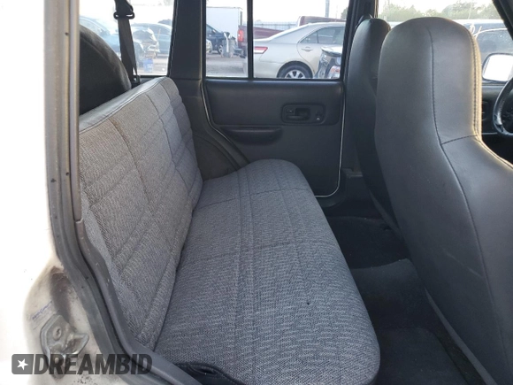 1999 Jeep Cherokee Sport with VIN 1J4FT68S6XL578679, listed as a Copart auction lot 76697394 with 196,110 mi miles and Salvage title. Bid and sale history available at DreamBid. Image 11.