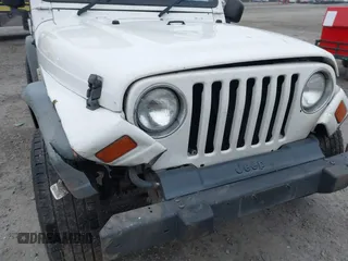 2006 Jeep Wrangler Sport Right Hand Drive with VIN 1J4F449S16P709895, listed as a IAAI auction lot 41349311 with 157,125 mi miles. Bid and sale history available at carsss.com. Image 18.