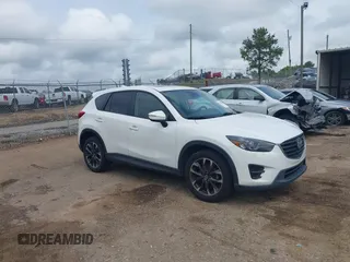 2016 Mazda CX-5 Grand Touring z VIN JM3KE2DY8G0629433, wystawiony jako IAAI lot #42104660 z przebiegiem 125 426 mil mil oraz . Historia ofert i sprzedaży dostępna na DreamBid. Obrazek 1.