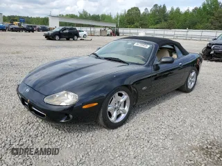 1999 Jaguar XK with VIN SAJGX2044XC031383, listed as a Copart auction lot 54726925 with 107,696 mi miles and Salvage Title. Bid and sale history available at DreamBid. Image 1.