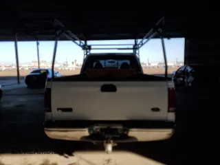 1999 Ford F-250 XL with VIN 1FTNX20FXXEE59499, listed as a Copart auction lot 87511735 with 215,520 mi miles and Salvage title. Bid and sale history available at DreamBid. Image 6.