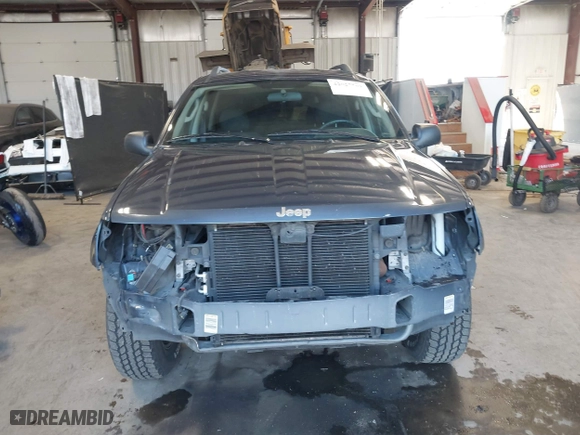 2003 Jeep Grand Cherokee Laredo with VIN 1J4GW48S33C539977, listed as a IAAI auction lot 42027703 with 100,534 mi miles. Bid and sale history available at carsss.com. Image 13.