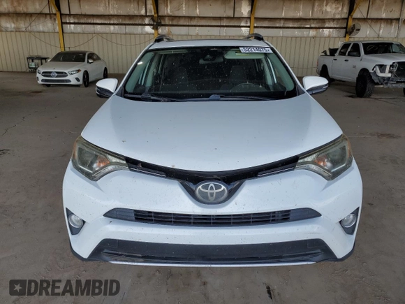 2018 Toyota RAV4 XLE with VIN JTMWFREV2JJ740145, listed as a Copart auction lot 52214075 with 129,940 mi miles and Salvage title. Bid and sale history available at DreamBid. Image 5.