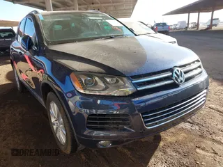 2014 Volkswagen Touareg Sport with VIN WVGEF9BPXED010016, listed as a IAAI auction lot 41218609 with 135,118 mi miles and . Bid and sale history available at DreamBid. Image 1.