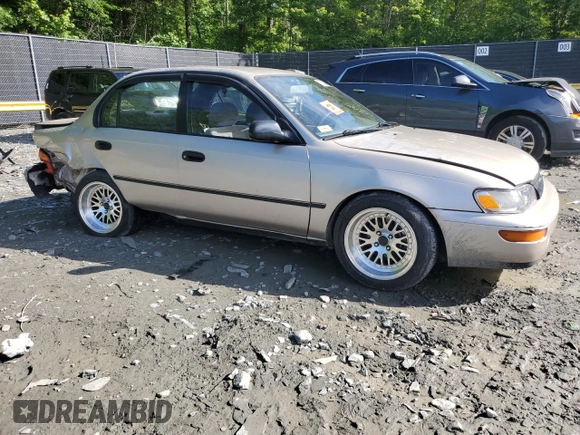 1995 Toyota Corolla DX with VIN 2T1AE09B0SC098739, listed as a Copart auction lot 57653205 with 154,226 mi miles and Salvage title. Bid and sale history available at DreamBid. Image 4.