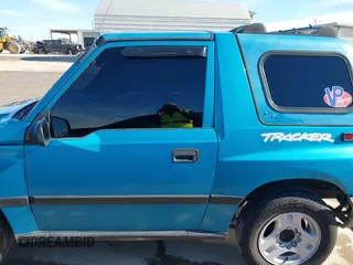 1997 Chevrolet Tracker z VIN 2CNBE1865V6904672, wystawiony jako IAAI lot #41296166 z przebiegiem 266 743 mil mil oraz . Historia ofert i sprzedaży dostępna na DreamBid. Obrazek 14.