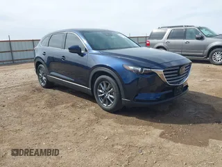 2023 Mazda CX-9 Touring z VIN JM3TCBCY1P0642455, wystawiony jako IAAI lot #41798252 z przebiegiem 24 204 mil mil oraz . Historia ofert i sprzedaży dostępna na DreamBid. Obrazek 1.