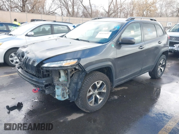 2015 Jeep Cherokee Trailhawk with VIN 1C4PJMBS9FW785545, listed as a IAAI auction lot 41573197 with 124,304 mi miles. Bid and sale history available at carsss.com. Image 2.