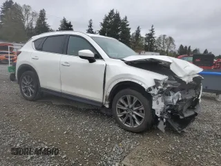 2021 Mazda CX-5 Signature with VIN JM3KFBEY3M0410998, listed as a Copart auction lot 54868885 with 73,207 mi miles and Salvage Title. Bid and sale history available at carsss.com. Image 4.