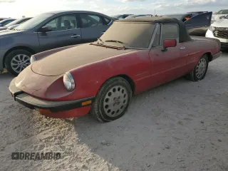 1990 Alfa Romeo Spider z VIN ZARBA12G6L6001683, wystawiony jako Copart lot #75611344 z przebiegiem 59 515 mil mil oraz Szkoda całkowita • Salvage title. Historia ofert i sprzedaży dostępna na DreamBid. Obrazek 1.