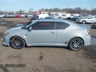 2014 Scion tC z VIN JTKJF5C71E3081033, wystawiony jako IAAI lot #41928949 z przebiegiem 144 112 mil mil oraz . Historia ofert i sprzedaży dostępna na DreamBid. Obrazek 14.