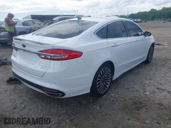 2017 Ford Fusion Titanium z VIN 3FA6P0K93HR203063, wystawiony jako IAAI lot #42243064 z przebiegiem 176 078 mil mil oraz . Historia ofert i sprzedaży dostępna na DreamBid. Obrazek 4.