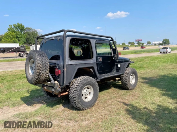1999 Jeep Wrangler Sahara with VIN 1J4FY49S5XP496486, listed as a Copart auction lot 54989365 with 128,498 mi miles and Clean Title. Bid and sale history available at carsss.com. Image 4.