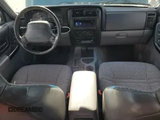 1997 Jeep Cherokee Sport with VIN 1J4FT68S4VL545385, listed as a Copart auction lot 49616325 with 239,798 mi miles and Salvage Title. Bid and sale history available at carsss.com. Image 8.