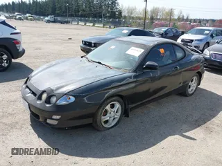 2000 Hyundai Tiburon z VIN KMHJG35F5YU191588, wystawiony jako IAAI lot #41934653 z przebiegiem 161 590 mil mil oraz . Historia ofert i sprzedaży dostępna na DreamBid. Obrazek 2.