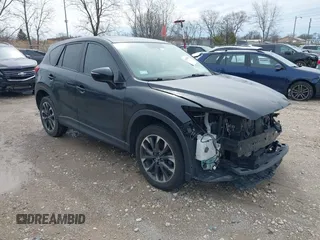 2016 Mazda CX-5 Grand Touring z VIN JM3KE2DY1G0621447, wystawiony jako IAAI lot #41954986 z przebiegiem 153 868 mil mil oraz . Historia ofert i sprzedaży dostępna na DreamBid. Obrazek 1.