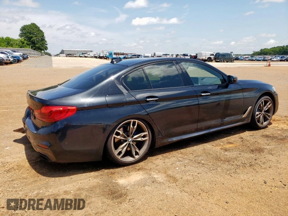 2018 BMW 5 Series M550i xDrive with VIN WBAJB9C54JB286450, listed as a Copart auction lot 61232125 with 88,479 mi miles and Salvage title. Bid and sale history available at DreamBid. Image 3.
