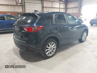 2015 Mazda CX-5 Grand Touring z VIN JM3KE4DYXF0490920, wystawiony jako IAAI lot #42367194 z przebiegiem 80 436 mil mil oraz . Historia ofert i sprzedaży dostępna na DreamBid. Obrazek 4.