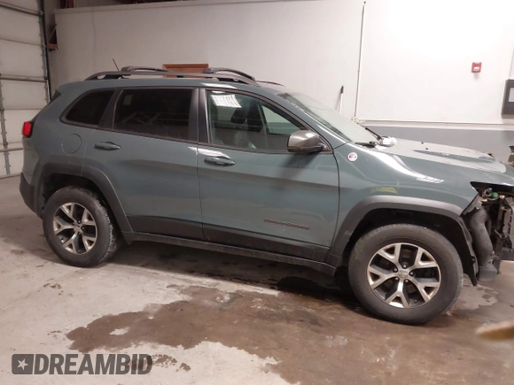2015 Jeep Cherokee Trailhawk with VIN 1C4PJMBS6FW724931, listed as a IAAI auction lot 41602181 with 153,340 mi miles and . Bid and sale history available at carsss.com. Image 14.