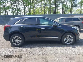 2021 Cadillac XT5 AWD Premium Luxury z VIN 1GYKNDRS8MZ217572, wystawiony jako IAAI lot #42190571 z przebiegiem 25 100 mil mil oraz . Historia ofert i sprzedaży dostępna na DreamBid. Obrazek 13.
