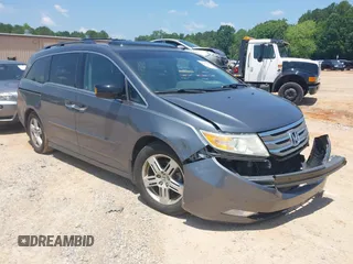 2011 Honda Odyssey Touring with VIN 5FNRL5H99BB043352, listed as a IAAI auction lot 42453040 with 143,452 mi miles and . Bid and sale history available at DreamBid. Image 1.