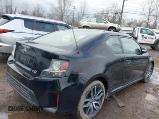 2014 Scion tC with VIN JTKJF5C74E3069104, listed as a IAAI auction lot 41579797 with 130,668 mi miles. Bid and sale history available at carsss.com. Image 4.