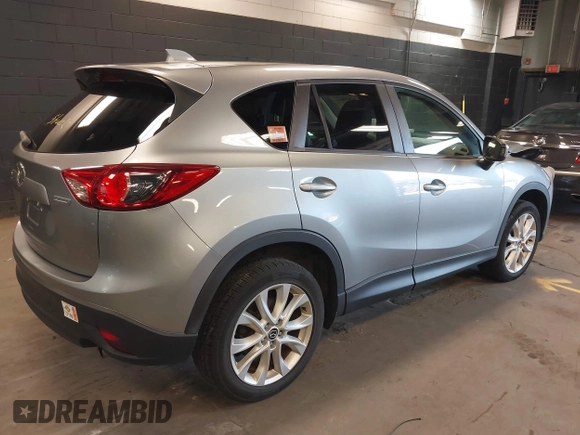 2014 Mazda CX-5 Grand Touring with VIN JM3KE4DY9E0373974, listed as a IAAI auction lot 42073693 with 86,755 mi miles. Bid and sale history available at carsss.com. Image 4.