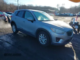 2014 Mazda CX-5 Touring z VIN JM3KE4CY9E0350387, wystawiony jako IAAI lot #41212641 z przebiegiem 191 413 mil mil oraz . Historia ofert i sprzedaży dostępna na DreamBid. Obrazek 1.