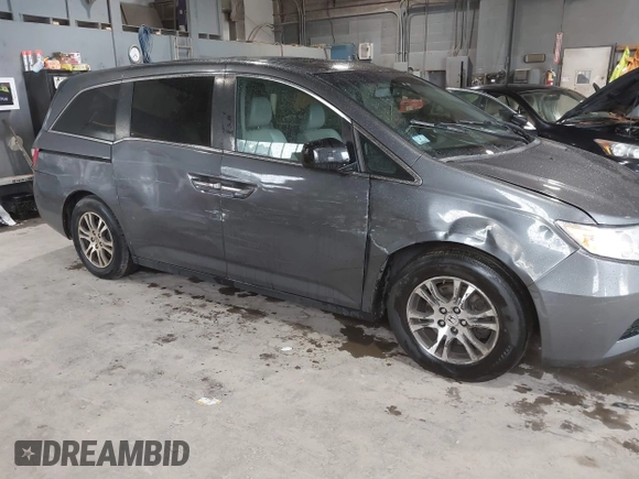 2012 Honda Odyssey EX-L with VIN 5FNRL5H63CB137198, listed as a IAAI auction lot 42706690 with 305,753 mi miles and . Bid and sale history available at DreamBid. Image 6.