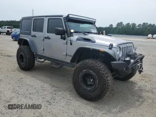 2013 Jeep Wrangler Unlimited Rubicon with VIN 1C4BJWFG5DL661282, listed as a Copart auction lot 57471035 with 128,400 mi miles and Salvage title. Bid and sale history available at DreamBid. Image 4.