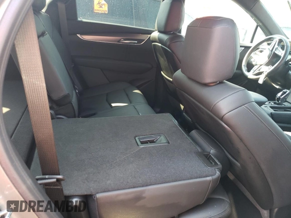 2023 Cadillac XT5 FWD Luxury z VIN 1GYKNAR4XPZ144533, wystawiony jako Copart lot #74734164 z przebiegiem Nie podano mil oraz Nie do naprawy • Non repairable. Historia ofert i sprzedaży dostępna na DreamBid. Obrazek 12.