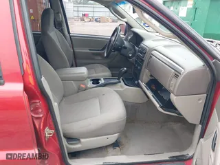 2004 Jeep Grand Cherokee Laredo with VIN 1J4GX48S14C259215, listed as a IAAI auction lot 41906121 with 142,668 mi miles. Bid and sale history available at carsss.com. Image 5.