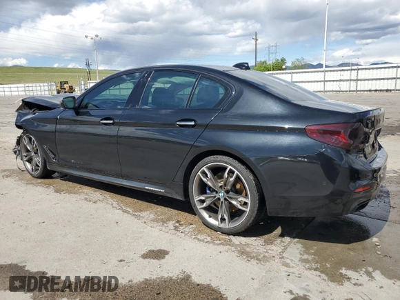 2018 BMW 5 Series M550i xDrive with VIN WBAJB9C55JB049384, listed as a Copart auction lot 54934435 with 79,061 mi miles and Non Repairable. Bid and sale history available at DreamBid. Image 2.