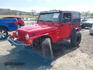 2002 Jeep Wrangler Sport with VIN 1J4FA49S42P771262, listed as a IAAI auction lot 41819403 with 132,871 mi miles. Bid and sale history available at carsss.com. Image 2.