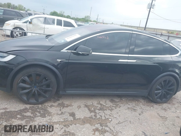 2021 Tesla Model X Long Range Plus with VIN 5YJXCAE27MF324270, listed as a IAAI auction lot 41886101 with 59,614 mi miles and . Bid and sale history available at carsss.com. Image 14.