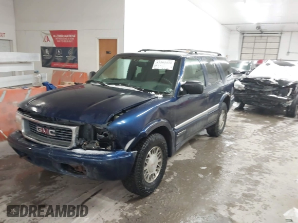 1999 GMC Jimmy SLE z VIN 1GKDT13W8X2534672, wystawiony jako IAAI lot #41562434 z przebiegiem 240 145 mil mil oraz . Historia ofert i sprzedaży dostępna na DreamBid. Obrazek 2.