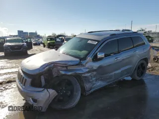 2014 Jeep Grand Cherokee Overland with VIN 1C4RJFCG2EC281062, listed as a Copart auction lot 47099225 with 127,660 mi miles and Salvage Title. Bid and sale history available at carsss.com. Image 1.