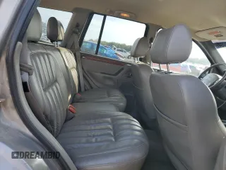 1999 Jeep Grand Cherokee Limited with VIN 1J4G268S7XC668348, listed as a Copart auction lot 77824084 with 165,779 mi miles and Salvage title. Bid and sale history available at DreamBid. Image 11.
