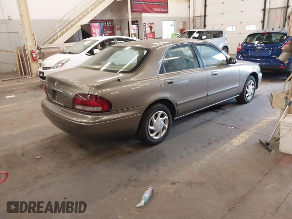 1999 Mazda 626 ES with VIN 1YVGF22C1X5852798, listed as a IAAI auction lot 41736489 with 136,536 mi miles. Bid and sale history available at carsss.com. Image 4.