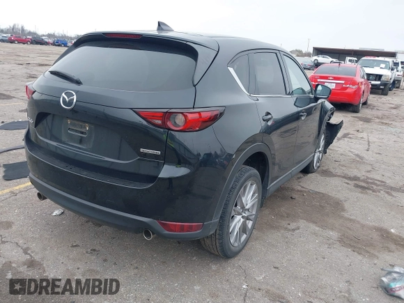 2020 Mazda CX-5 Grand Touring with VIN JM3KFADM8L0811910, listed as a IAAI auction lot 41446214 with 57,849 mi miles. Bid and sale history available at carsss.com. Image 4.