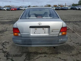 1996 Toyota Tercel DX z VIN JT2AC52L2T0137695, wystawiony jako Copart lot #86535844 z przebiegiem 246 554 mil mil oraz Czysty tytuł • Clean title. Historia ofert i sprzedaży dostępna na DreamBid. Obrazek 6.