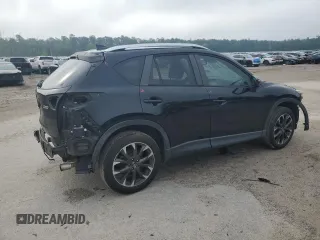 2016 Mazda CX-5 Grand Touring z VIN JM3KE2DY5G0676290, wystawiony jako Copart lot #54155325 z przebiegiem 124 743 mil mil oraz Szkoda całkowita • Salvage title. Historia ofert i sprzedaży dostępna na DreamBid. Obrazek 3.