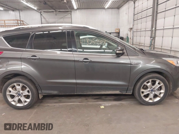2015 Ford Escape Titanium with VIN 1FMCU9J96FUA43337, listed as a IAAI auction lot 41825328 with 149,639 mi miles and . Bid and sale history available at DreamBid. Image 14.