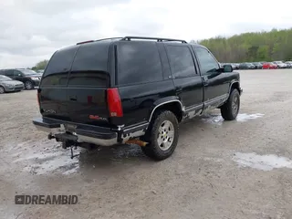 1996 GMC Yukon with VIN 1GKEK13R0TJ739663, listed as a IAAI auction lot 41942883 with 411,219 mi miles. Bid and sale history available at carsss.com. Image 4.