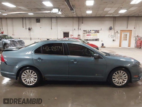 2012 Ford Fusion Hybrid z VIN 3FADP0L31CR443545, wystawiony jako IAAI lot #42028774 z przebiegiem 194 365 mil mil oraz . Historia ofert i sprzedaży dostępna na DreamBid. Obrazek 13.