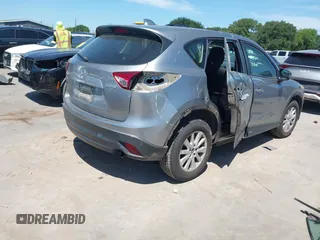 2014 Mazda CX-5 Sport with VIN JM3KE2BE7E0371203, listed as a IAAI auction lot 42243756 with 121,534 mi miles and . Bid and sale history available at DreamBid. Image 4.