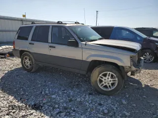 1997 Jeep Grand Cherokee Laredo with VIN 1J4GZ58S5VC561060, listed as a Copart auction lot 52098315 with 267,245 mi miles and Salvage title. Bid and sale history available at DreamBid. Image 4.