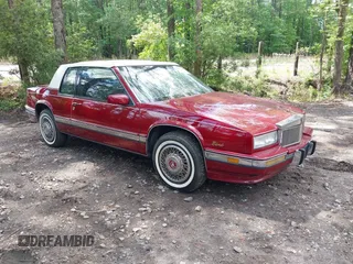 1990 Cadillac Eldorado z VIN 1G6EL1333LU608572, wystawiony jako IAAI lot #42191060 z przebiegiem 105 433 mil mil oraz . Historia ofert i sprzedaży dostępna na DreamBid. Obrazek 1.