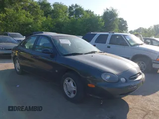 1999 Ford Taurus SE Comfort z VIN 1FAFP53S3XG104165, wystawiony jako IAAI lot #42234147 z przebiegiem 183 124 mil mil oraz . Historia ofert i sprzedaży dostępna na DreamBid. Obrazek 1.