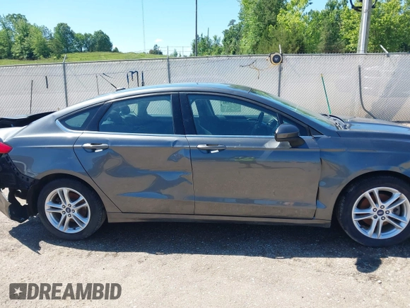 2018 Ford Fusion SE z VIN 3FA6P0H71JR155221, wystawiony jako IAAI lot #42145081 z przebiegiem 189 367 mil mil oraz . Historia ofert i sprzedaży dostępna na DreamBid. Obrazek 14.